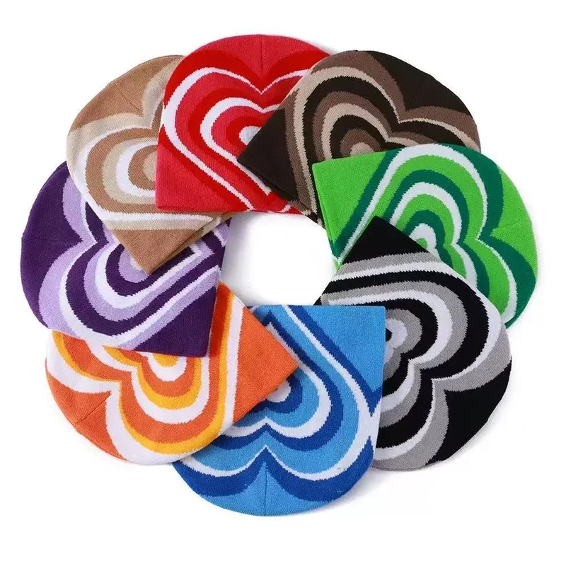 Assorted heart pattern knit beanies arranged in a circle