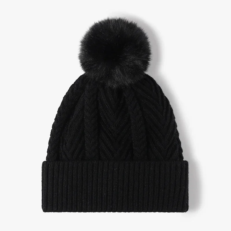 Black cable-knit winter beanie with pom-pom