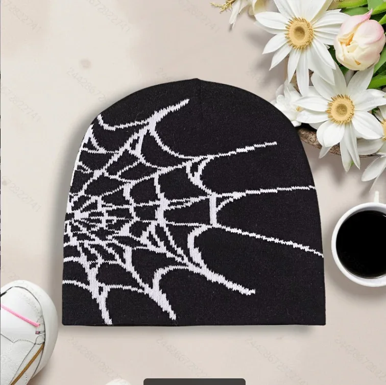 Black knit beanie with a fine white spiderweb motif
