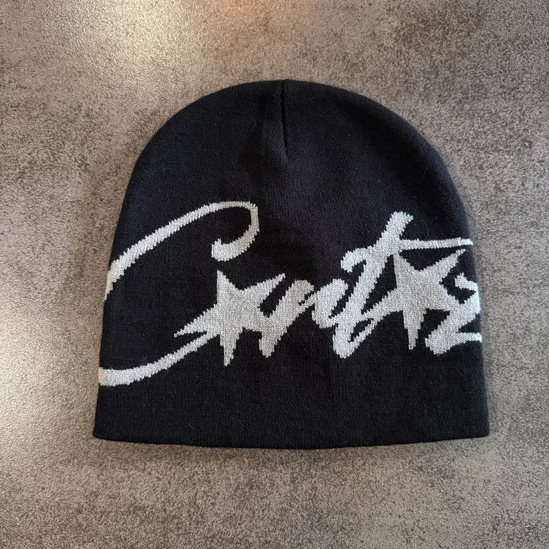 Black knit beanie with oversized grey script lettering