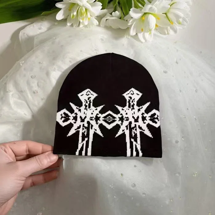 Black knit beanie with white cross motifs
