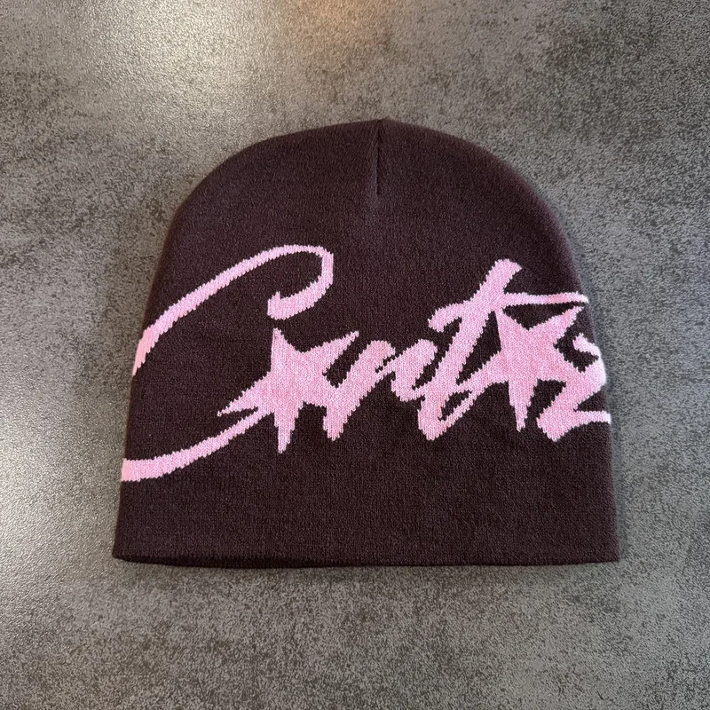 Brown knit beanie with oversized pink script lettering