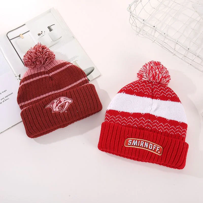 Burgundy and red pom pom beanies with contrasting front patches