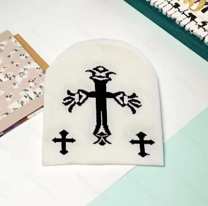 Cream knit beanie with black cross motifs