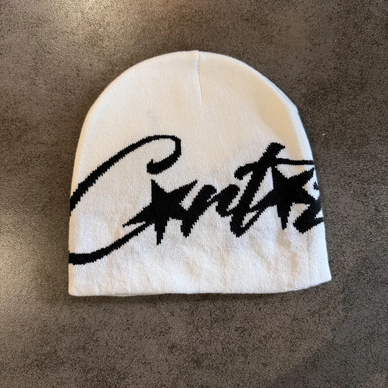 Cream knit beanie with large black script lettering