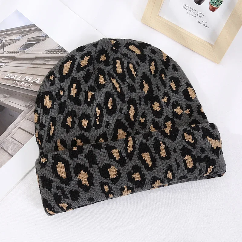 Dark grey knit beanie with a black and tan leopard pattern