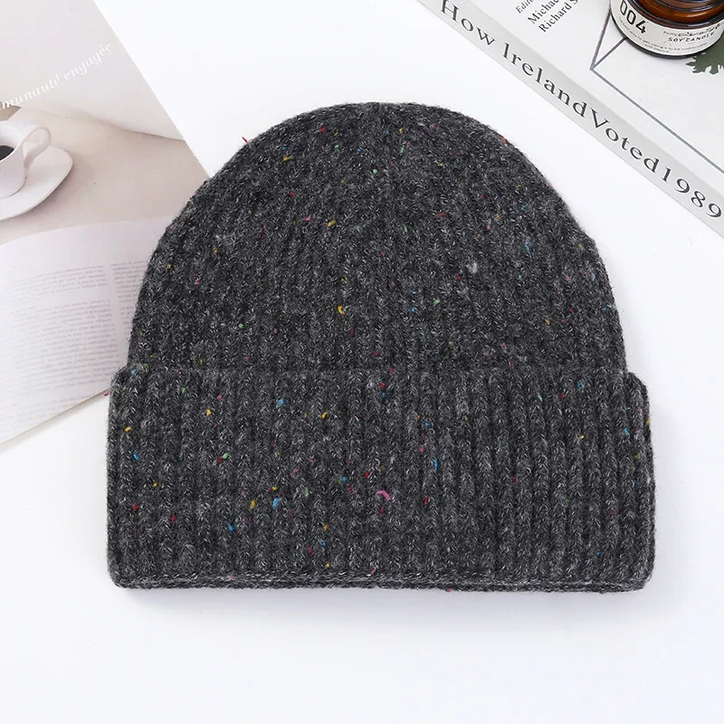 Dark grey rib knit beanie with a folded cuff photographed flat