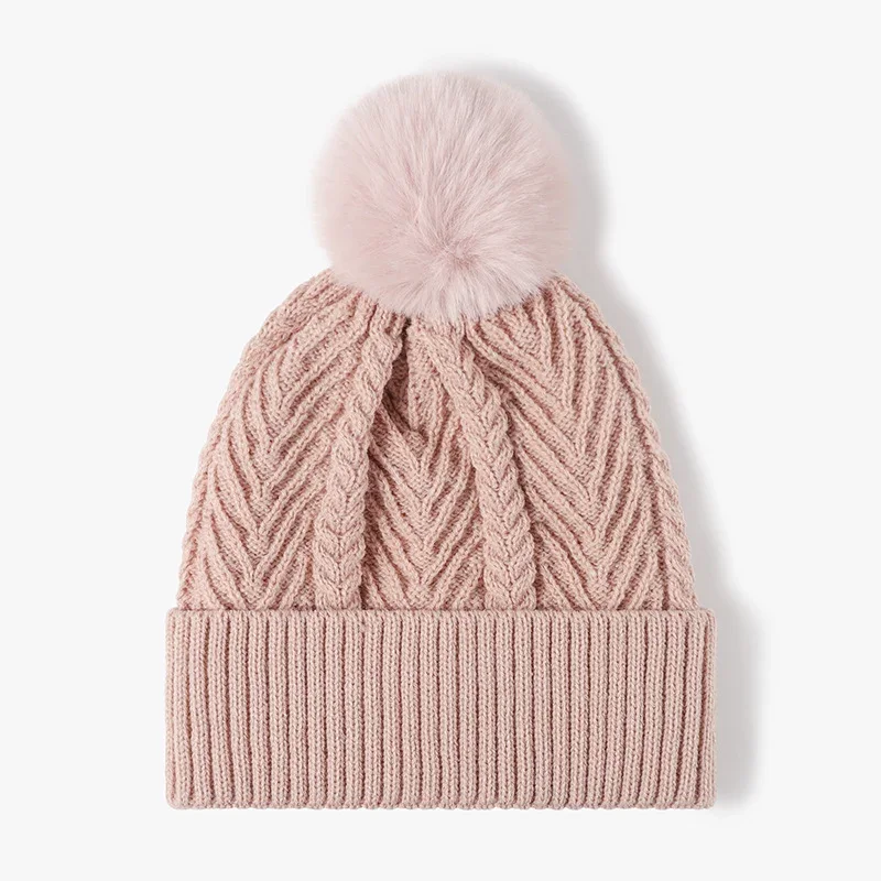 Pink cable-textured knitted beanie with a ribbed cuff and pom-pom