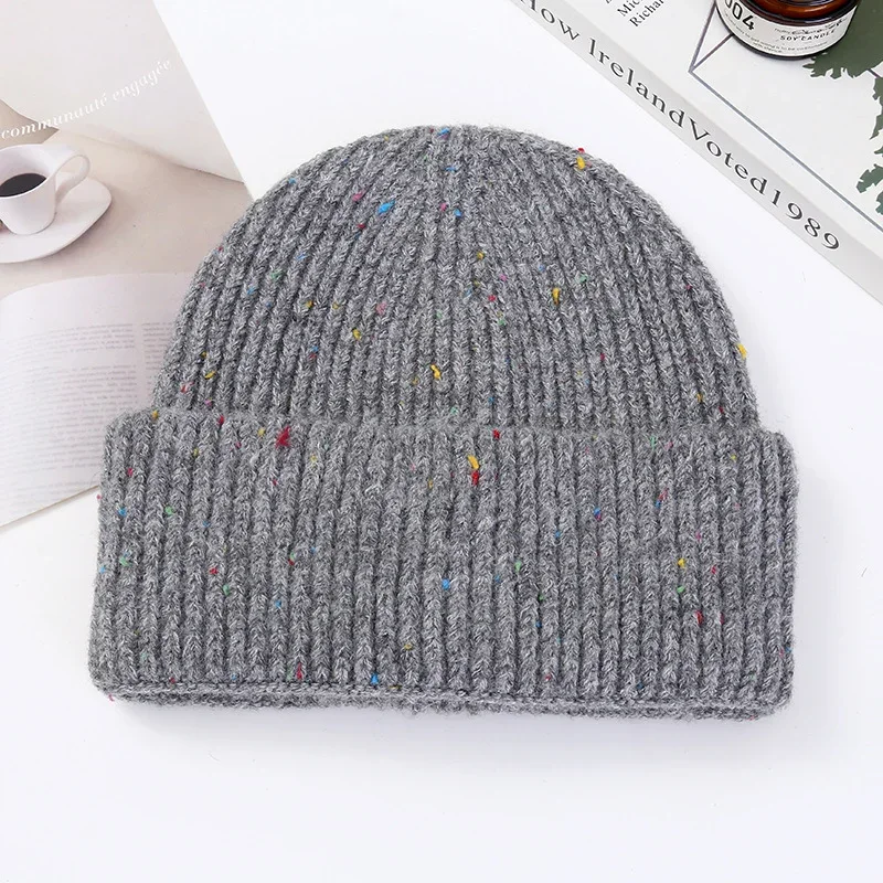 Grey rib knit beanie with a folded cuff photographed flat