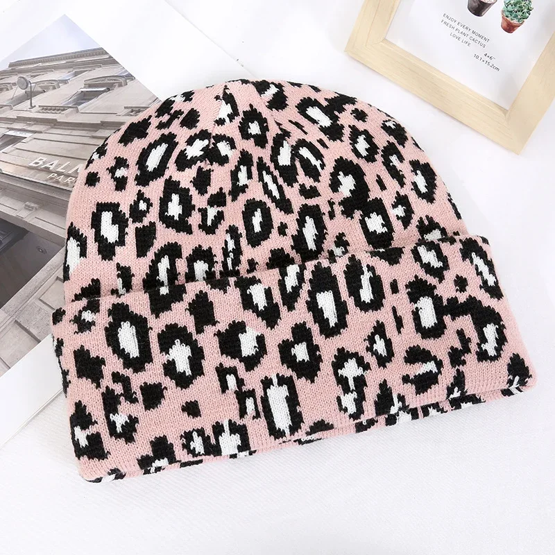 Pink knit beanie with a black leopard pattern