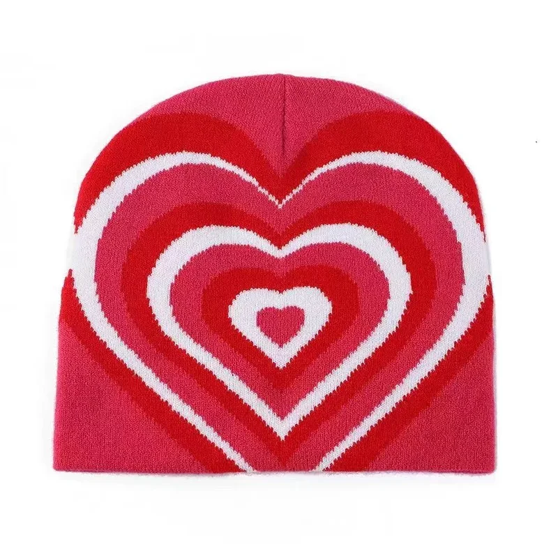 Red knit beanie with concentric pink and white heart motifs