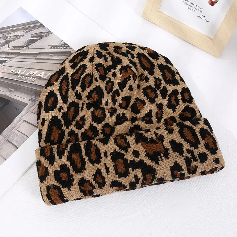 Tan knit beanie with a black and brown leopard pattern