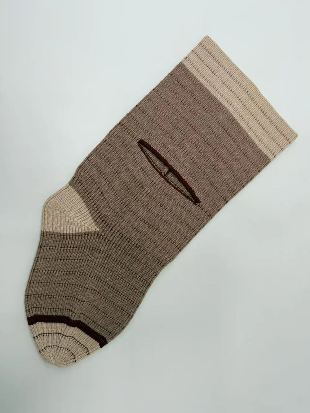 Taupe rib knit sample laid flat with a slit opening and contrasting knit