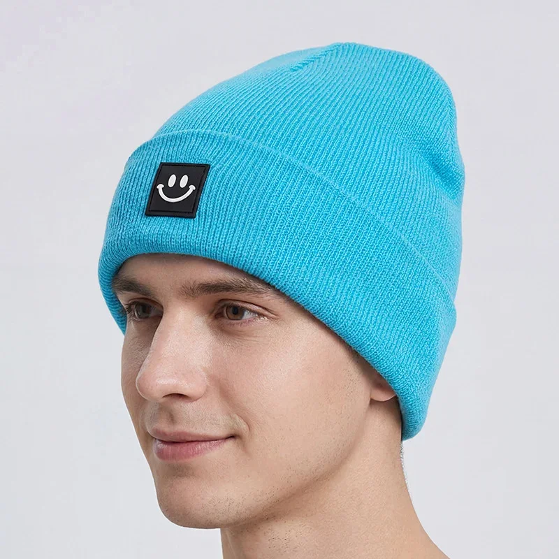Turquoise cuffed knit beanie with a black smile label on a mannequin