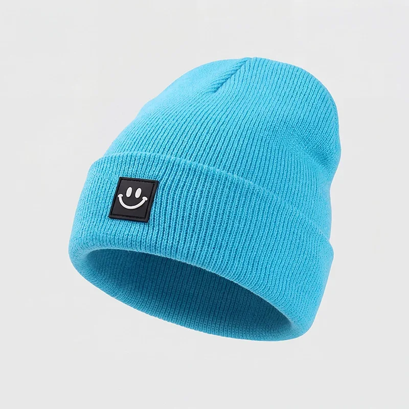 Turquoise cuffed knit beanie with a square smile label