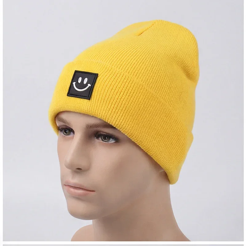 Yellow cuffed knit beanie with a black smile label on a mannequin